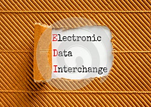 EDI electronic data interchange symbol. Concept words EDI electronic data interchange on white paper on a beautiful brown