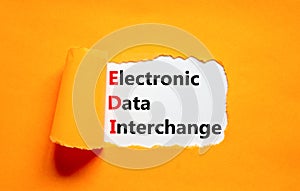 EDI electronic data interchange symbol. Concept words EDI electronic data interchange on white paper on a beautiful orange