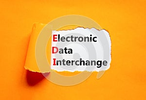 EDI electronic data interchange symbol. Concept words EDI electronic data interchange on white paper on a beautiful orange