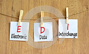 EDI electronic data interchange symbol. Concept words EDI electronic data interchange on white paper on a beautiful wooden