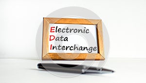 EDI electronic data interchange symbol. Concept words EDI electronic data interchange on wooden frame. Beautiful white background