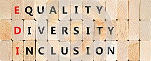 EDI equality diversity inclusion symbol. Concept words EDI equality diversity inclusion on blocks on a beautiful wooden background