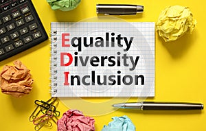 EDI equality diversity inclusion symbol. Concept words EDI equality diversity inclusion on white note. Beautiful yellow background
