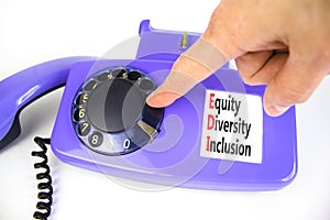 EDI equity diversity inclusion symbol. Concept words EDI equity diversity inclusion on old disk phone. Beautiful white background
