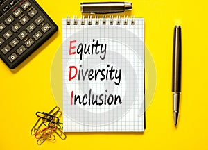 EDI equity diversity inclusion symbol. Concept words EDI equity diversity inclusion on white note. Beautiful yellow background.