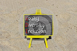 EDI equity diversity inclusion symbol. Concept words EDI equity diversity inclusion on yellow blackboard. Beautiful sand