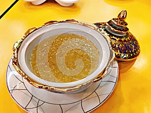 Edible bird`s nest soup in benjarong Thai porcelain with designs in five colours bowl.
