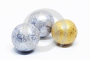 Edible candy that resembles silver and gold balls