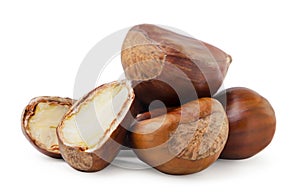 Edible chestnuts heap whole and half on a white background. Isolated