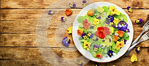 Edible flower salad in the plate,copy space