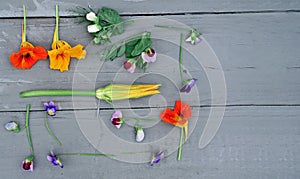 Edible flowers on a grey table. food knolling