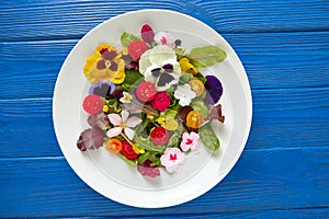 Edible flowers salad in a plate photo