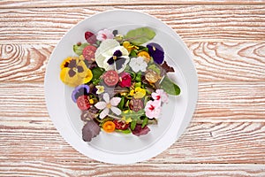 Edible flowers salad in a plate photo