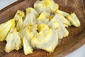 Edible part of marolo, araticum or bruto fruit on wooden bowl . Tropical fruit of the original inhabitants of Brazil and photo