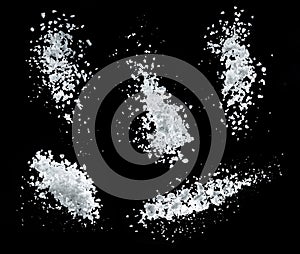 Edible salt crystals falling down at black background