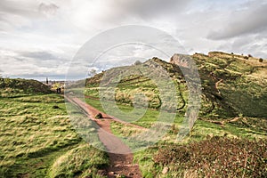 Edinburgh and Arthur& x27;s Seat in a beautiful day, Scotland, United Kingdom. Hills and mountains with path