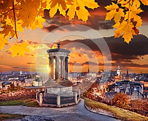 Edinburgh with Calton Hill against autumn leaves in Scotland