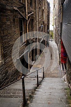 EDINBURGH, SCOTLAND - April 2018: An alley with stairs near the Royal Mile in the Old Town in Edinburgh Scotland. The