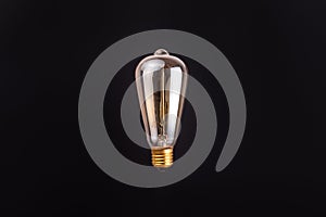 edison lamp on an isolated black background. Levitation with copyspace. Concept ecology, save planet earth, idea, save energy,