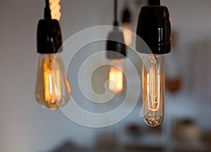 Edison lamp with warm light sways lightly background. Warm.
