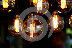 Edison light bulb hanging on a long wire. Cozy warm yellow light.Retro