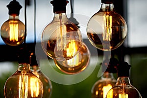 Edison light bulb hanging on a long wire. Cozy warm yellow light.Retro