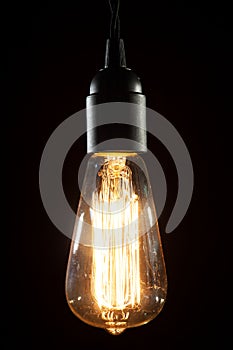 Edison light bulb on wooden background