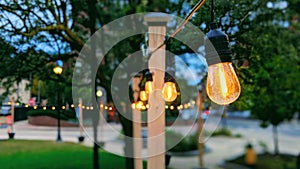 Edison lights hang romantically in public garden in downtown Augusta, Maine photo
