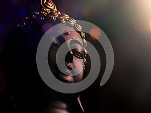 edited image of laughing buddha idol with abstract and glow lights