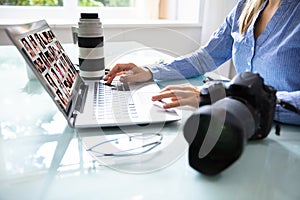 Editor Retouching Photos On Laptop photo