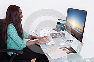 Editor using digital tablet at photo agency photo