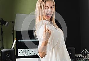 Editor woman smiling confident happy raising her hand look at camera in recording studio