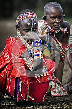 Editorial Photo Massai tribe women on holiday in the beautiful jewelry and clothes, sitting on the ground in his village