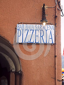 Editorial pizzeria restaurant sign on old building in Vernazza Cinque Terre Italy