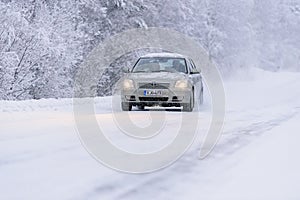 Editorial: Tuupovaara City, Finland, 25th December 2018. Toyota car on the road number 496 with heavy snow in winter season at