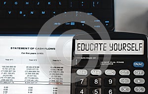 EDUCATE YOURSELF - concept of text on calculator display. Top view
