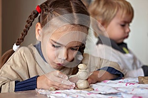 Education and art, kid playing with modeling clay in pottery workshop, craft and clay art