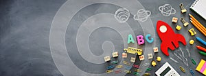 Education. Back to school concept. wooden red rocket over blackboard background. top view, flat lay