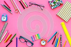 Education background, frame. School, student, office supplies. Stationery, glasses, alarm clock, notebook on pink