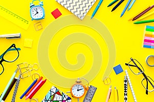 Education background, mockup. School, student, office supplies. Stationery, glasses, alarm clock, notebook on yellow