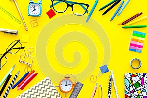 Education background, mockup. School, student, office supplies. Stationery, glasses, alarm clock, notebook on yellow