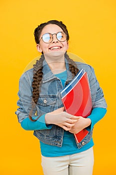 Education is a basic right. Happy child hold books yellow background. School education. Private teaching. Private lesson