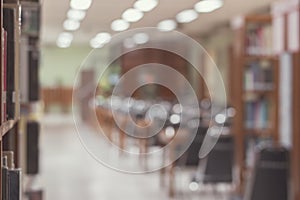 Education blur background of books on bookshelf in blurry school library, study room or classroom