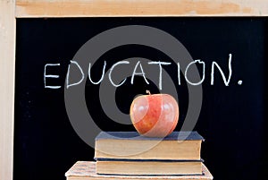 EDUCATION on chalkboard with apple & books