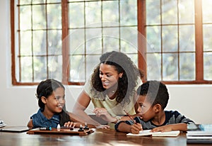 Education, children and mother with girl, boy and doing homework or learning on a dining room table or parent and