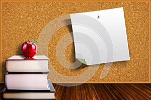 Education Concept With Apple on Books and Corkboard Background