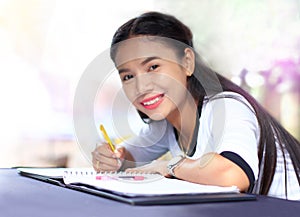 Education concept,asian woman sitting by wooden with writing lecture