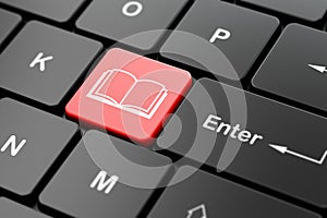 Education concept: Book on computer keyboard background