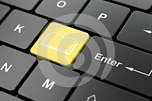Education concept: Book on computer keyboard background