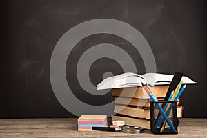 Education concept - books on the desk in the auditorium